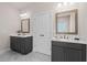 Bathroom showcasing double vanity sinks with dark gray cabinets and framed mirrors at 627 Skytop Dr, Cumming, GA 30040