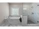 Luxurious bathroom with a separate glass shower and soaking tub at 627 Skytop Dr, Cumming, GA 30040
