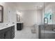Bright bathroom featuring a glass shower and tub, gray tile floor, and a gray vanity at 627 Skytop Dr, Cumming, GA 30040