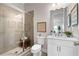 Modern bathroom with glass-enclosed shower, white cabinets, and neutral tile at 627 Skytop Dr, Cumming, GA 30040
