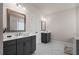 Spacious bathroom featuring double vanity sinks, gray tile flooring, and framed mirrors at 627 Skytop Dr, Cumming, GA 30040