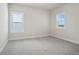 A cozy bedroom with plush carpeting and two windows providing natural light at 627 Skytop Dr, Cumming, GA 30040