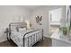 Cozy bedroom with dark-stained hardwood floors, a metal bed frame, and white walls at 627 Skytop Dr, Cumming, GA 30040