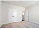 A light and airy bedroom with double closet doors and neutral carpeting at 627 Skytop Dr, Cumming, GA 30040