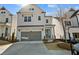 Beautiful two-story home featuring a gray two car garage and complementary landscaping at 627 Skytop Dr, Cumming, GA 30040