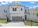 Charming two-story home with a gray two car garage and a landscaped front yard at 627 Skytop Dr, Cumming, GA 30040