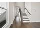 Inviting foyer with hardwood flooring, staircase, and views of the entryway at 627 Skytop Dr, Cumming, GA 30040