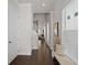 Bright foyer with hardwood floors, bench and staircase leading to the second floor at 627 Skytop Dr, Cumming, GA 30040