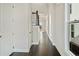Hallway with beautiful hardwood flooring, white walls, and lots of natural light at 627 Skytop Dr, Cumming, GA 30040