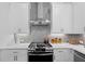 Stylish kitchen features stainless oven, herringbone backsplash, white countertops, and white cabinets at 627 Skytop Dr, Cumming, GA 30040