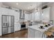 Bright kitchen features stainless appliances, herringbone backsplash, white cabinets, and island seating at 627 Skytop Dr, Cumming, GA 30040