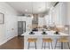 Bright kitchen with stainless appliances, herringbone backsplash, white cabinets and wooden barstools at 627 Skytop Dr, Cumming, GA 30040