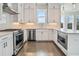 Modern kitchen with white cabinets, stainless steel appliances, and hardwood floors at 627 Skytop Dr, Cumming, GA 30040