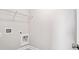 Practical laundry room with a utility sink, washer hookups, and wire shelving at 627 Skytop Dr, Cumming, GA 30040