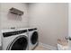 Laundry room featuring modern white washer and dryer at 627 Skytop Dr, Cumming, GA 30040