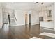 Spacious living room featuring hardwood floors, a staircase, and adjacent kitchen area at 627 Skytop Dr, Cumming, GA 30040