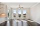 Living room featuring hardwood floors, white walls, three large windows, and ceiling fan at 627 Skytop Dr, Cumming, GA 30040