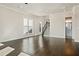 Spacious living room featuring hardwood floors, recessed lighting, and staircase at 627 Skytop Dr, Cumming, GA 30040