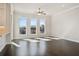Living room featuring hardwood floors, white walls, three large windows, and ceiling fan at 627 Skytop Dr, Cumming, GA 30040