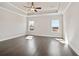 Spacious main bedroom showcasing hardwood floors, tray ceiling, and great natural light at 627 Skytop Dr, Cumming, GA 30040