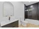 Modern bathroom with black tiled shower, white vanity, and gold fixtures at 906 Mcdaniel St, Atlanta, GA 30310