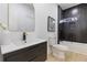 Modern bathroom featuring a dark vanity and tiled shower with updated fixtures and ample lighting at 906 Mcdaniel St, Atlanta, GA 30310