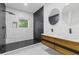 Modern bathroom featuring double vessel sinks, a wood vanity, and a glass-enclosed shower with dark tile at 906 Mcdaniel St, Atlanta, GA 30310