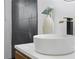 Modern bathroom vanity with a white bowl sink, black faucet, and black tiled backsplash at 906 Mcdaniel St, Atlanta, GA 30310
