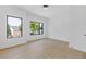 Bright bedroom with large windows offering a green outdoor view, complemented by light wood floors at 906 Mcdaniel St, Atlanta, GA 30310