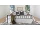 Bright and airy bedroom featuring a wrought iron bed frame, modern decor, and ample natural light from large windows at 906 Mcdaniel St, Atlanta, GA 30310