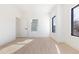 Bright, minimalist bedroom with light hardwood floors and black-trimmed windows allowing natural light at 906 Mcdaniel St, Atlanta, GA 30310