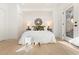 Bright bedroom featuring a large bed, french doors to the backyard and neutral decor at 906 Mcdaniel St, Atlanta, GA 30310