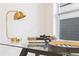 Desk with a gold lamp, decor, and a glass top at 906 Mcdaniel St, Atlanta, GA 30310