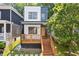 Modern two-story home features a mixed facade, wooden deck, and landscaped front yard at 906 Mcdaniel St, Atlanta, GA 30310