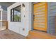 Modern front door with side window, porch, and modern exterior light fixture at 906 Mcdaniel St, Atlanta, GA 30310