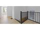 Light-filled hallway with modern black railing, crisp white walls, and sleek wood floors at 906 Mcdaniel St, Atlanta, GA 30310