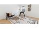 Bright home office features a modern glass desk and stylish decor on a decorative rug and wood floors at 906 Mcdaniel St, Atlanta, GA 30310