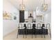 Open concept kitchen with white cabinets, black island and modern lighting at 906 Mcdaniel St, Atlanta, GA 30310