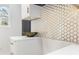 Chic white kitchen features gold honeycomb backsplash, white cabinets and counters at 906 Mcdaniel St, Atlanta, GA 30310