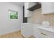 Bright kitchen features white cabinets, gold hardware, modern backsplash, and window to outdoors at 906 Mcdaniel St, Atlanta, GA 30310