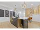Bright kitchen features a black island, white countertops, modern light fixtures, open floor plan, and eat-in dining area at 906 Mcdaniel St, Atlanta, GA 30310