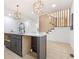 Modern kitchen island with black cabinetry, white countertops, pendant lighting and modern staircase at 906 Mcdaniel St, Atlanta, GA 30310