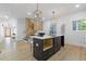 Bright kitchen features a black island, white countertops, modern light fixtures, and an open floor plan at 906 Mcdaniel St, Atlanta, GA 30310
