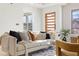 Bright living room featuring a cozy sofa, stylish decor, and natural light from large windows at 906 Mcdaniel St, Atlanta, GA 30310