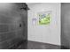 Modern walk-in shower featuring black and white tiles and a rainfall shower head at 906 Mcdaniel St, Atlanta, GA 30310