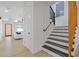 Bright home interior featuring a modern staircase with black and wood railings, and light wood floors at 906 Mcdaniel St, Atlanta, GA 30310