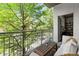 Charming balcony with cozy seating, a small table, and serene outdoor views at 245 N Highland Ne Ave # 220, Atlanta, GA 30307