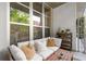 Inviting balcony featuring cozy seating and views of green trees through large windows at 245 N Highland Ne Ave # 220, Atlanta, GA 30307