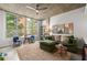 Bright living room featuring a large window, modern fan, and contemporary furnishings at 245 N Highland Ne Ave # 220, Atlanta, GA 30307