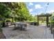 A spacious outdoor patio with a dining area, complete with pavers, mature trees, and a pergola at 245 N N Highland Ne Ave # 220, Atlanta, GA 30307